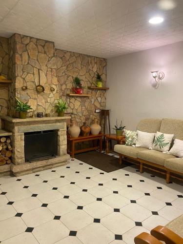 a living room with a fireplace and a stone wall at Charming 8-Bed Villa in Girona in Girona
