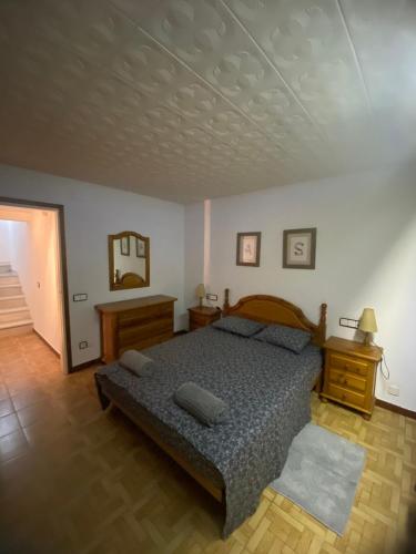 a bedroom with a bed and a mirror on the wall at Charming 8-Bed Villa in Girona in Girona