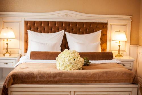 a bedroom with a large bed with flowers on it at Nadiya Hotel in Ivano-Frankivsʼk