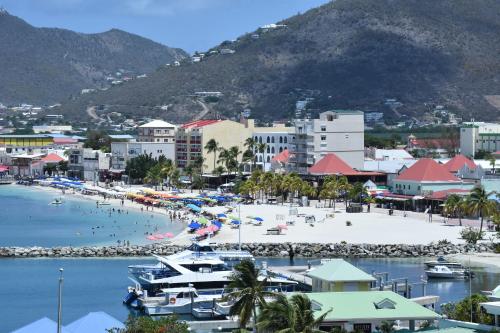 a beach with a bunch of boats in the water at The Aquila Villa in Philipsburg