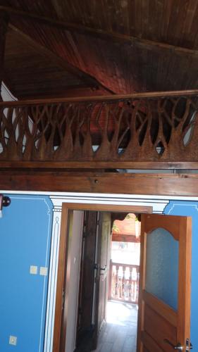 a room with a wooden ceiling and a door with a mirror at Недкова къща in Koprivshtitsa