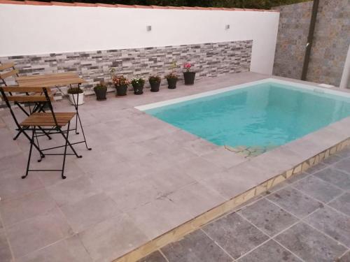 a pool with a table and chairs in a patio at La magia del sur 2 in Cádiz