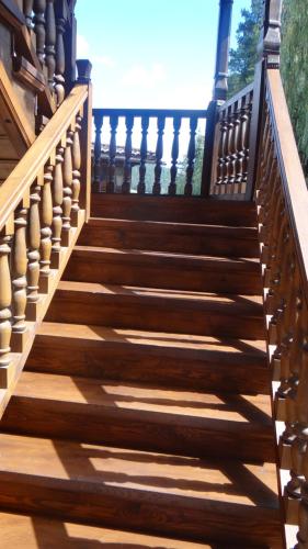 a wooden staircase with wooden railings on a house at Недкова къща in Koprivshtitsa