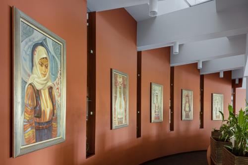 a row of paintings on the wall of a museum at Pirin Park Hotel in Sandanski