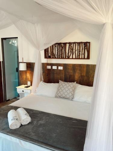 a bed with two white pillows on top of it at Quinta da Bocaina in Amparo