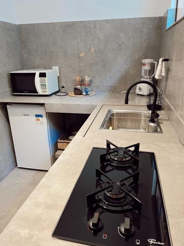 a kitchen with a stove and a sink in it at Quinta da Bocaina in Amparo