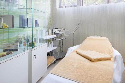 a hospital room with a bed in a room with a window at Pirin Park Hotel in Sandanski