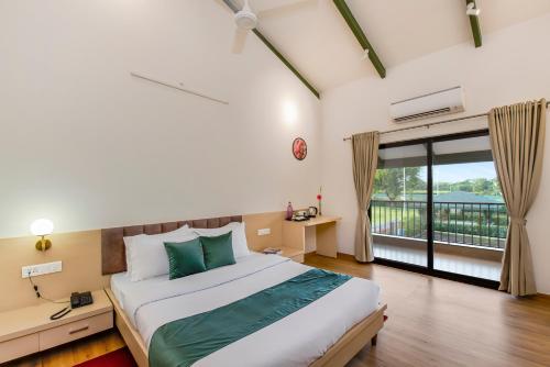 a bedroom with a large bed and a balcony at SaffronStays Amaltas, Nashik - pool villa with huge lawns perfect for large groups and corporate offsites in Nashik