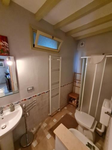 a bathroom with a toilet and a sink at A casa di Bianca in Portacomaro
