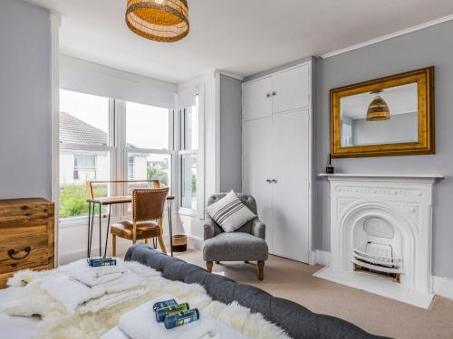 a living room with a couch and a fireplace at Pass the Keys Delightful 2 Bed House a Stones Throw From Beach in Bognor Regis