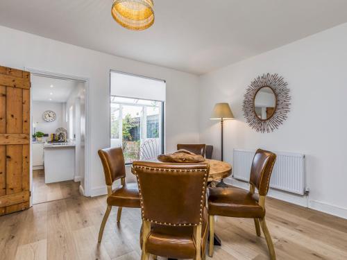 a dining room with a table and chairs at Pass the Keys Delightful 2 Bed House a Stones Throw From Beach in Bognor Regis
