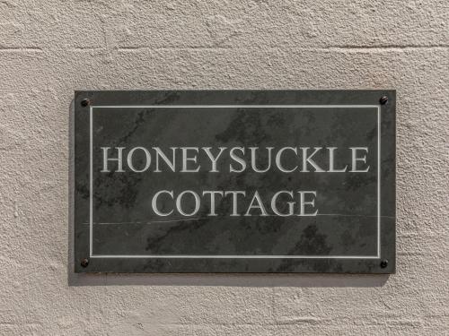 a sign on the side of a building with the words honey uptake coffee at Pass the Keys Delightful 2 Bed House a Stones Throw From Beach in Bognor Regis