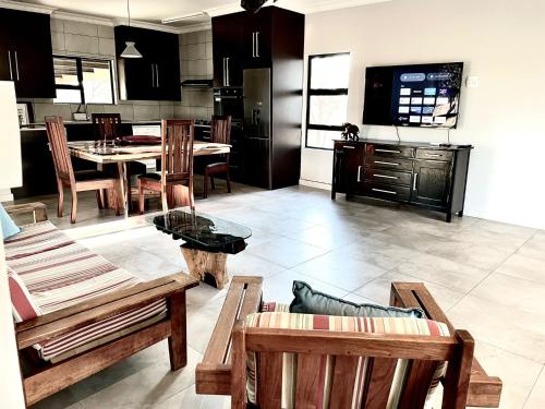 a kitchen and living room with a table and chairs at Bushveld Magic in Klipdrift