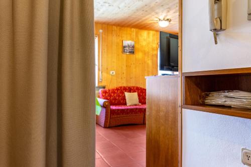 a living room with a couch and a television at Pension Sonia App 103 in Funes