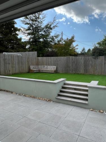 a garden with a bench and a wooden fence at Green 3 bed bungalow with en-suite and parking in Felton