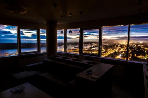 a room with a window with a view of a city at sky DREAM jacuzzi sauna 33 FLOOR in Klaipėda
