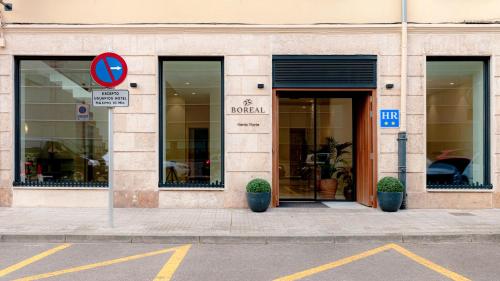 a building with a sign in front of a store at Hotel Boreal Viento Norte in Burgos