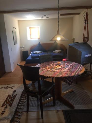 a living room with a table and a couch at Haus der Sinne in Obernberg am Inn