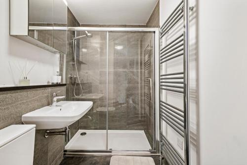 a bathroom with a shower and a sink at The Sleek Gem of Central Wakefield - Parking in Wakefield