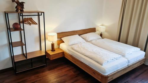 a bedroom with a bed with two lamps on it at Dill Hotel in Ilsede
