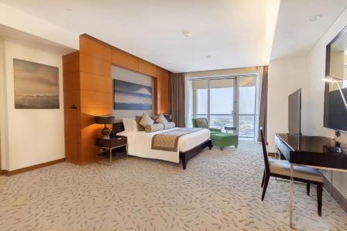 a hotel room with a bed and a television at Emaar Fashion Avenue - Formerly Address Dubai Mall Four Apple in Dubai