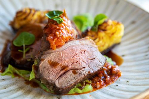 a plate of food with meat and beans on it at Heacham Manor Hotel in Hunstanton