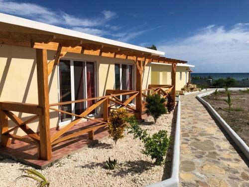 a building on the beach with the ocean in the background at Punta Rucia Cristal Beach in Punta Rucia