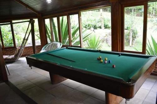 a pool table in a living room with afits at Vista Linda Hotel in Itatiaia
