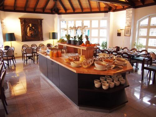a large room with a counter with food on it at Falderhof in Cologne
