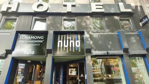 a building with a sign on the front of it at NunoHotel in Cologne