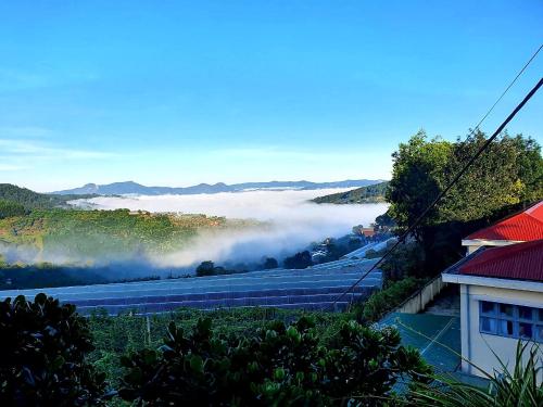 a view of a field with clouds in the distance at Mr.Khanh Coffee in Xuân Trường