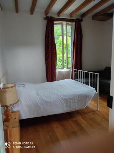 a bedroom with a bed and a window at Lulu in Castelmoron-sur-Lot