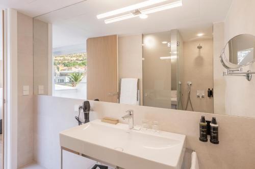 a bathroom with a sink and a mirror at Eurostars Pórtico Alicante in Alicante