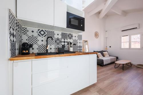 une cuisine avec un comptoir et un salon dans l'établissement LE NID DU PANIER - Climatisé - Proche vieux port, à Marseille