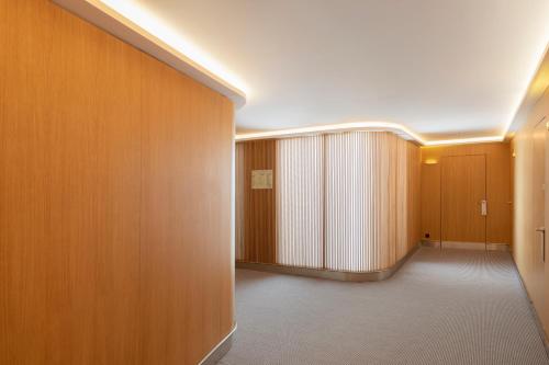 a hallway with wood paneled walls and a hallway with a door at Eurostars Pórtico Alicante in Alicante