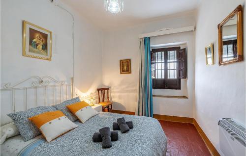 a bedroom with a bed with a blue blanket at Nice Home In Trasmulas, Granada With 5 Bedrooms, Wifi And Outdoor Swimming Pool in Trasmulas