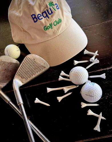 a baseball cap and a bunch of golf clubs at Firefly Estate Bequia in Crescent Beach