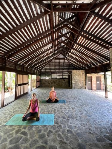 two people sitting in a room doing yoga at Firefly Estate Bequia in Crescent Beach