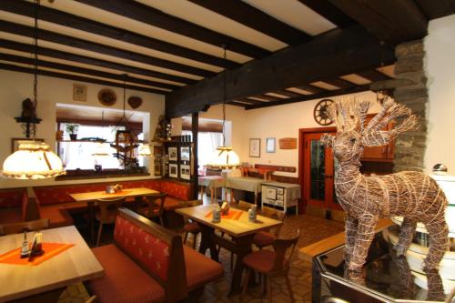 a restaurant with a statue of a giraffe in the middle at Hotel Brunneck in Schönau am Königssee