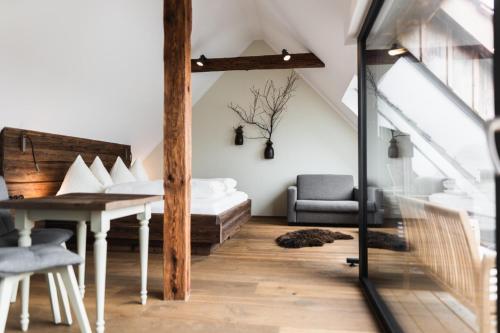 a living room with a bed and a table at Weingut Kögl in Ratsch an der Weinstraße