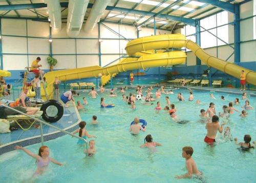 a large group of people in a swimming pool at Golden Palm, Meadow Lakes 8, Chapel St Leonards in Chapel Saint Leonards