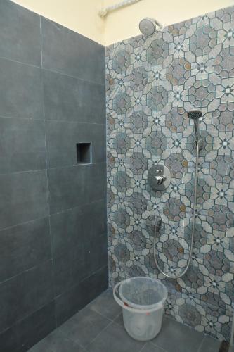 a bathroom with a shower with a toilet in it at KANS ONE - Madipakkam in Chennai