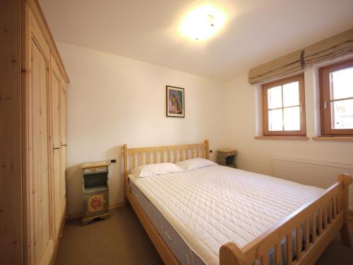 a bedroom with a bed and a window at Appartamenti Home Service in Arabba