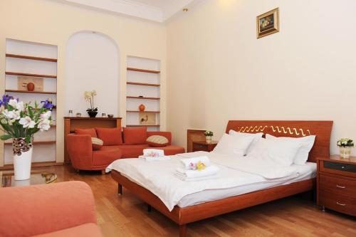 a bedroom with a bed and a couch in it at Premium Rent in Kiev Centre - Kiev in Kyiv