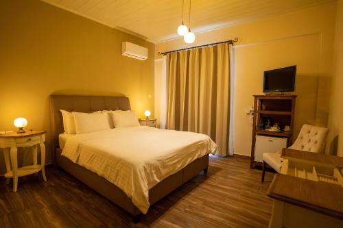 a hotel room with a bed and a television at Guesthouse Laoula in Gerolimenas