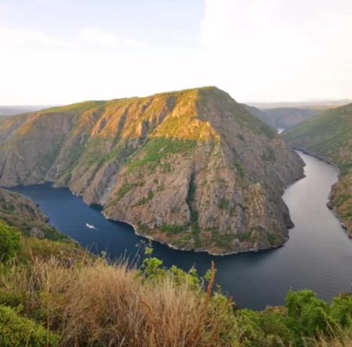 a large mountain with a lake in the middle at Casa Leirón in Parada del Sil