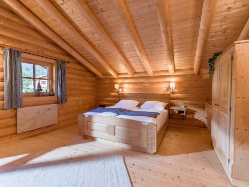 a bedroom with a bed in a log cabin at Audorfer Blockhaus in Oberaudorf