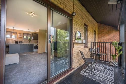 a large glass door leading to a patio with a table at Waterlily Apartment - Beautiful 1-bed with overlooking balcony in Nottingham