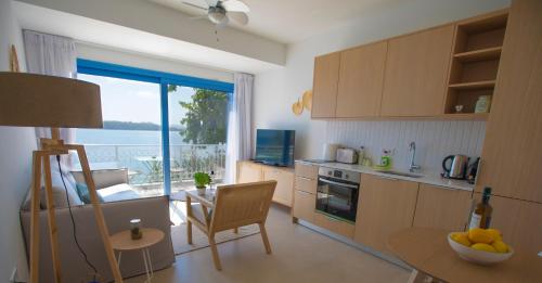a kitchen with a table and a dining room with a view at Greek Beach House A3 Lefkada in Nydri
