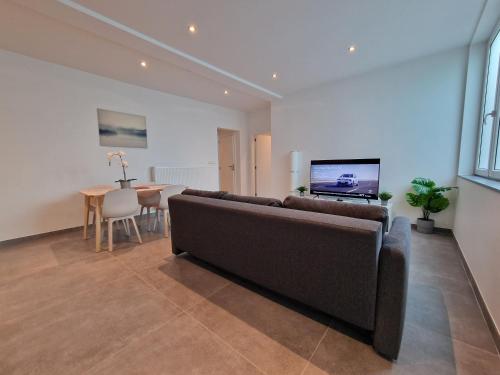 a living room with a couch and a table at Appart-Hotel Léopold Liège Centre in Liège